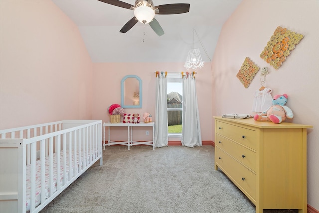 bedroom with carpet flooring, lofted ceiling, a nursery area, and ceiling fan