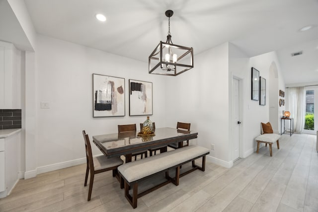 dining space with light wood-style floors, a chandelier, baseboards, and recessed lighting