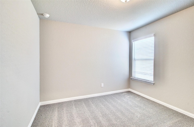 4426 Azalea Blossom Rd, Pinehurst, TX 77362 - carpeted spare room with baseboards, a textured ceiling, and a smoke detector