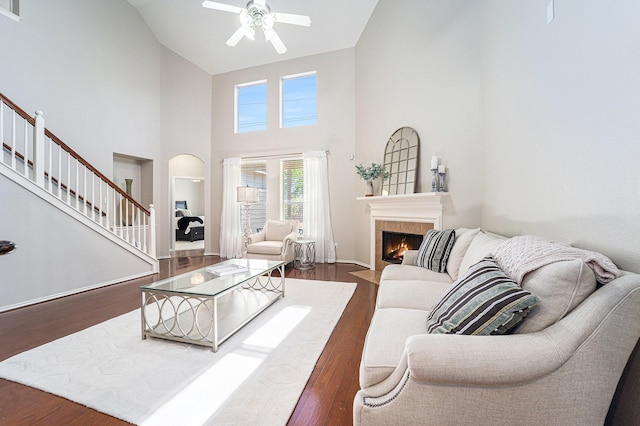 11018 Jadestone Creek Ln, Cypress, TX 77433 - living room with a ceiling fan, high vaulted ceiling, stairway, wood finished floors, and a fireplace