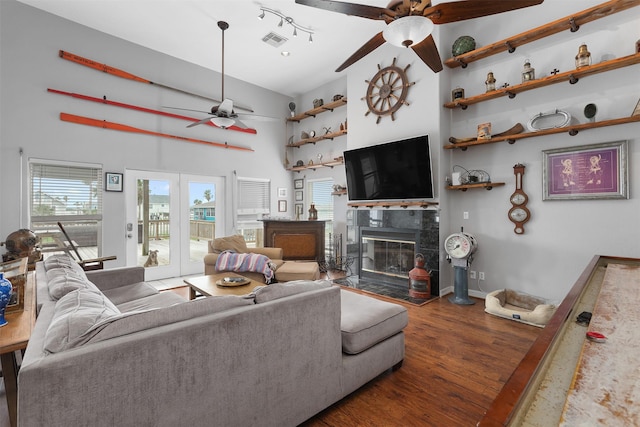 3802 Tidewater, Galveston, TX 77554 - living area with ceiling fan, a tiled fireplace, wood finished floors, and a towering ceiling
