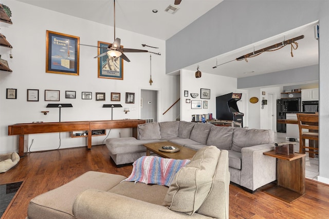 3802 Tidewater, Galveston, TX 77554 - living area featuring a ceiling fan, wood finished floors, a high ceiling, and stairs