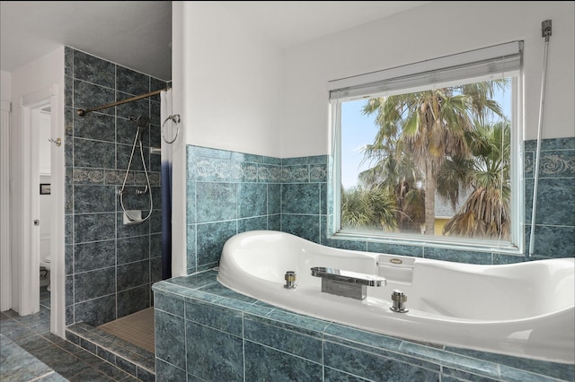 3802 Tidewater, Galveston, TX 77554 - full bathroom with a garden tub, a tile shower, toilet, and tile walls