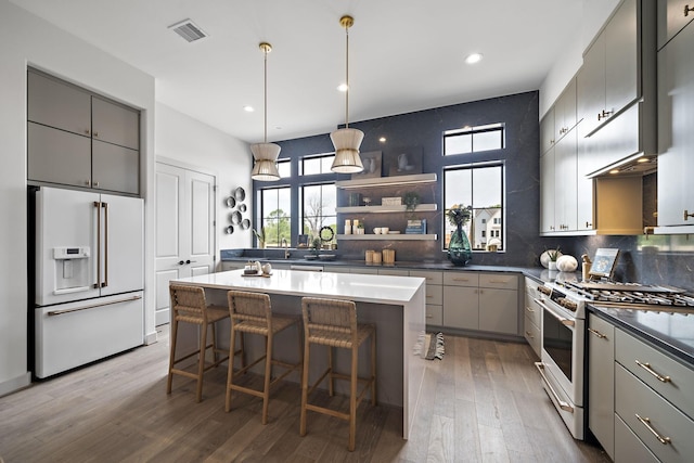 1716 Sedola Ln, Houston, TX 77055 - kitchen with white appliances, gray cabinets, plenty of natural light, and recessed lighting