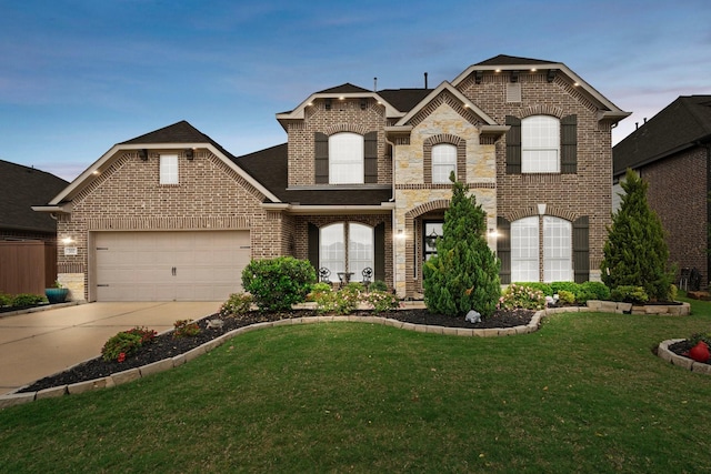 202 Bentwater Ln, Clute, TX 77531 - french country home with brick siding, a front lawn, driveway, roof with shingles, and an attached garage