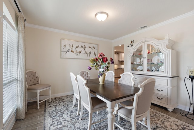 202 Bentwater Ln, Clute, TX 77531 - dining area with ornamental molding, wood finished floors, and baseboards