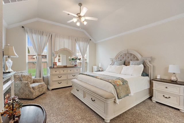 202 Bentwater Ln, Clute, TX 77531 - bedroom featuring lofted ceiling, light colored carpet, ornamental molding, ceiling fan, and a lit fireplace