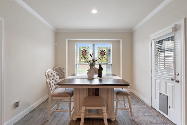 202 Bentwater Ln, Clute, TX 77531 - dining space with baseboards, crown molding, and wood finished floors
