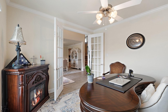 202 Bentwater Ln, Clute, TX 77531 - office area featuring french doors, wood finished floors, ornamental molding, ceiling fan, and a glass covered fireplace