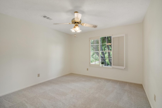 unfurnished room featuring light carpet, baseboards, and ceiling fan