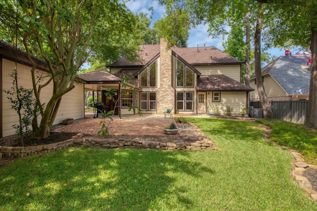 back of house with a patio, a chimney, a shingled roof, and central AC unit