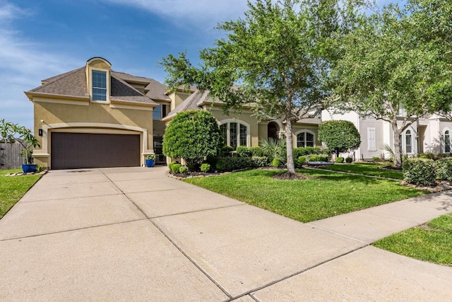 4528 Estella Ct, League City, TX 77573 - view of front of house with stucco siding, a front lawn, a garage, and concrete driveway