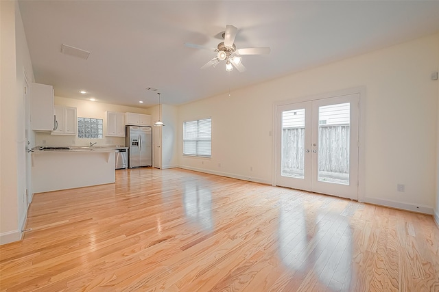 3722 Main Poplar Dr, Houston, TX 77025 - unfurnished living room featuring light wood-style flooring, ceiling fan, french doors, baseboards, and recessed lighting