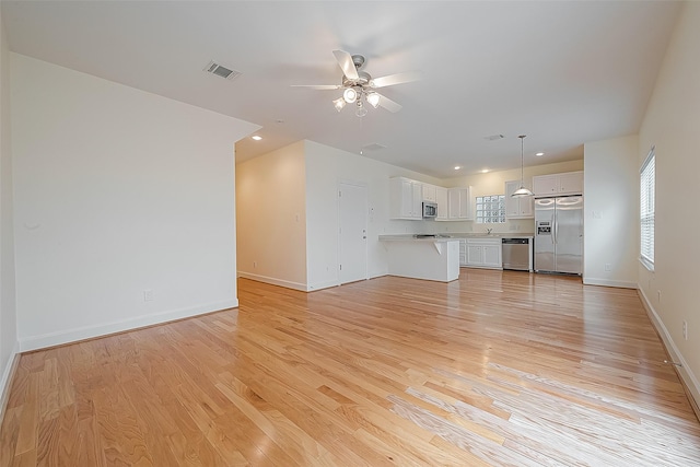 3722 Main Poplar Dr, Houston, TX 77025 - unfurnished living room featuring light wood-style floors, a ceiling fan, baseboards, and recessed lighting