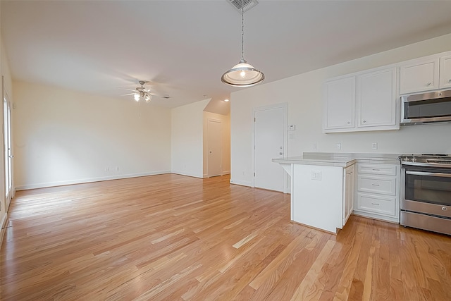 3722 Main Poplar Dr, Houston, TX 77025 - kitchen featuring appliances with stainless steel finishes, white cabinetry, a peninsula, ceiling fan, and light countertops