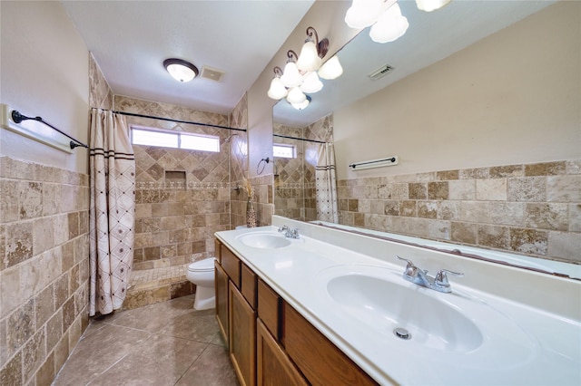 7810 Broken Arrow St, Baytown, TX 77521 - full bath with tile walls, toilet, tiled shower, tile patterned flooring, and double vanity