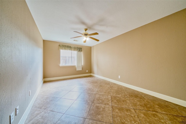 7810 Broken Arrow St, Baytown, TX 77521 - tiled spare room featuring a ceiling fan, a textured wall, and baseboards