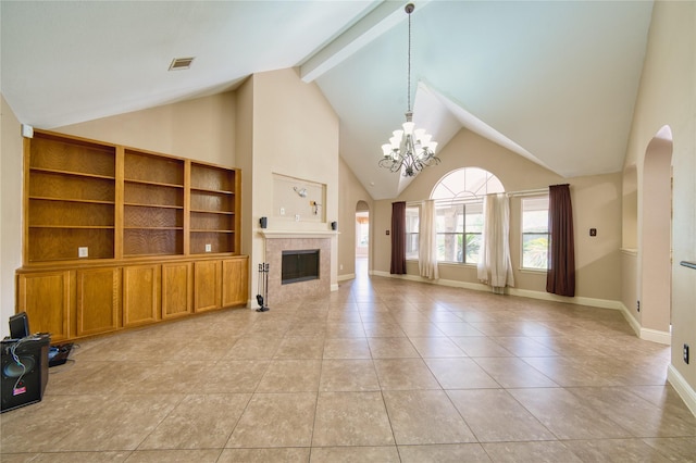 7810 Broken Arrow St, Baytown, TX 77521 - unfurnished living room featuring arched walkways, a chandelier, a fireplace, light tile patterned floors, and high vaulted ceiling