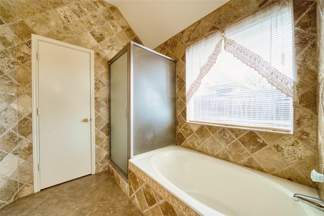7810 Broken Arrow St, Baytown, TX 77521 - full bathroom featuring a bath, a shower stall, tile walls, and tile patterned floors