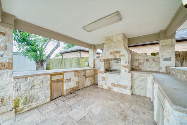 7810 Broken Arrow St, Baytown, TX 77521 - view of patio featuring fence and exterior kitchen