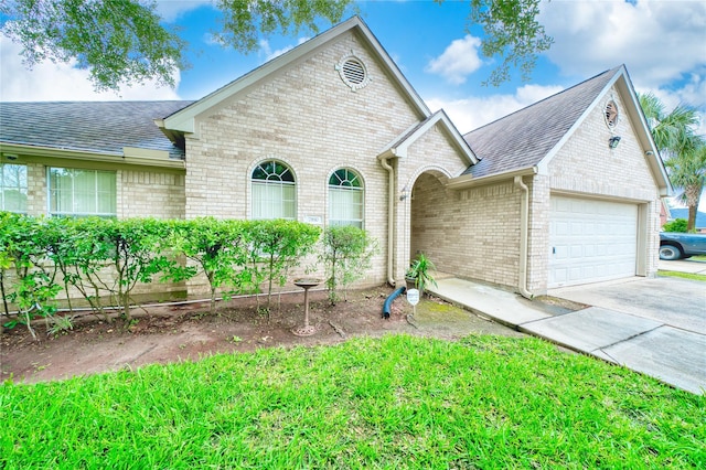 7810 Broken Arrow St, Baytown, TX 77521 - view of front of property featuring brick siding, driveway, roof with shingles, and an attached garage