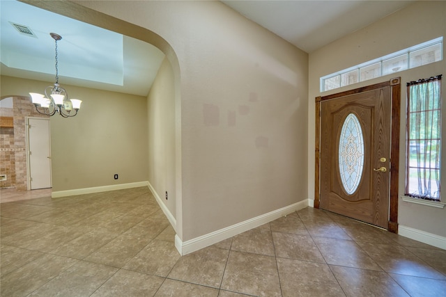 7810 Broken Arrow St, Baytown, TX 77521 - entrance foyer featuring a chandelier, light tile patterned floors, baseboards, and arched walkways