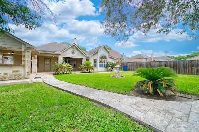 7810 Broken Arrow St, Baytown, TX 77521 - view of front of home with a chimney and stone siding