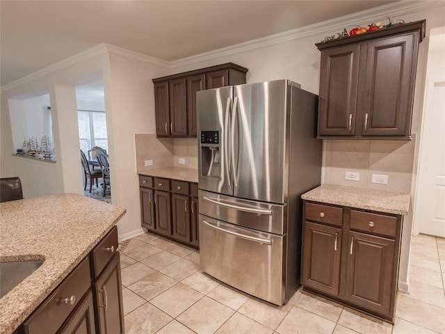 2786 Cayden Creek Way, Conroe, TX 77304 - kitchen featuring stainless steel fridge, backsplash, dark brown cabinetry, crown molding, and light tile patterned floors