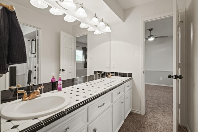 13102 Lake Mist Dr, Cypress, TX 77429 - full bathroom with double vanity, ceiling fan, and baseboards