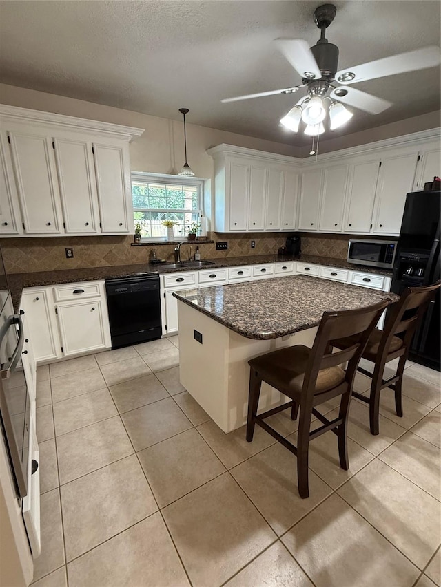 13102 Lake Mist Dr, Cypress, TX 77429 - kitchen featuring black appliances, tasteful backsplash, and white cabinets