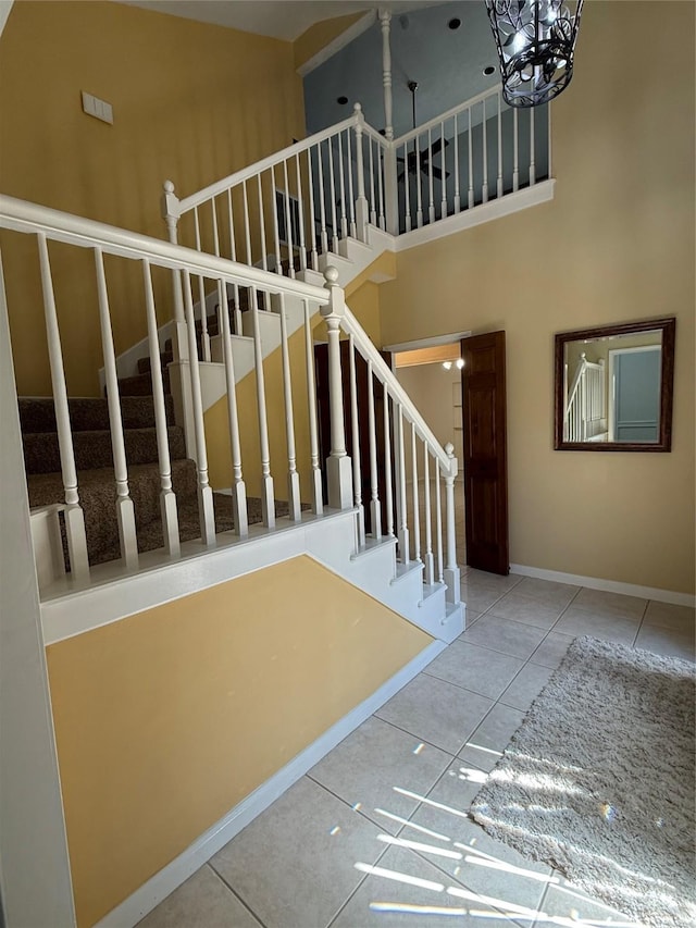 13102 Lake Mist Dr, Cypress, TX 77429 - stairs featuring a towering ceiling, a chandelier, and tile patterned flooring