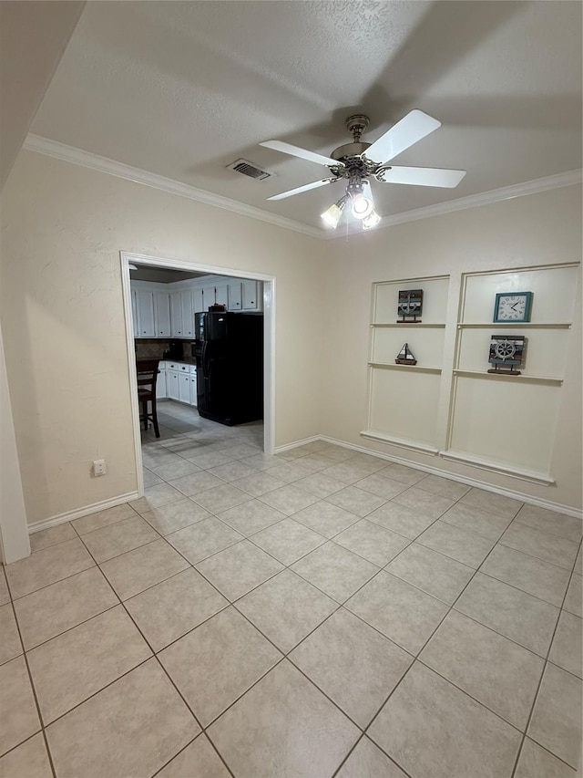 13102 Lake Mist Dr, Cypress, TX 77429 - spare room with ornamental molding, a ceiling fan, a textured ceiling, light tile patterned flooring, and built in shelves