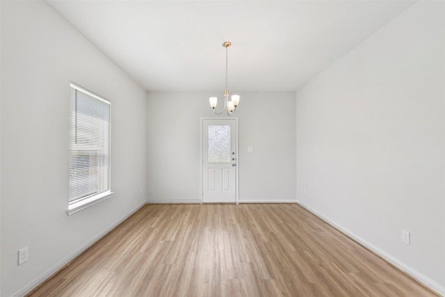 3907 Lynnfield St, Houston, TX 77016 - spare room with wood finished floors, a chandelier, and baseboards