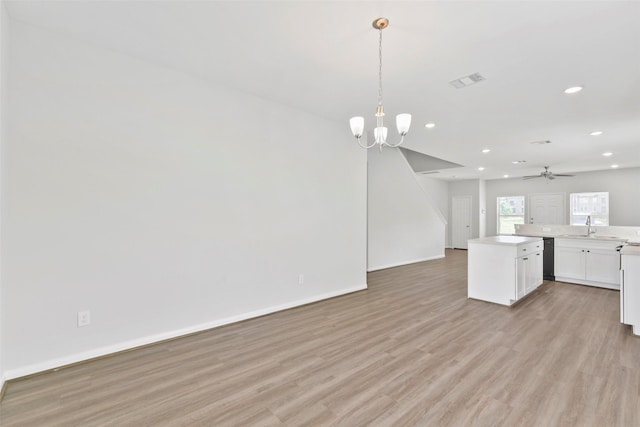 3907 Lynnfield St, Houston, TX 77016 - kitchen with open floor plan, recessed lighting, light wood-style flooring, white cabinetry, and light countertops