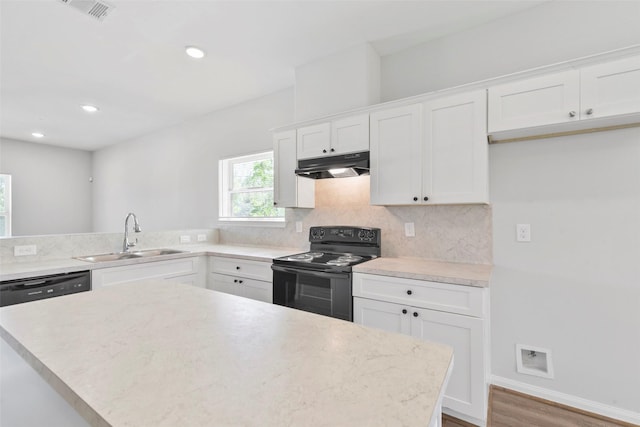 3907 Lynnfield St, Houston, TX 77016 - kitchen featuring black range with electric stovetop, under cabinet range hood, a sink, light countertops, and recessed lighting