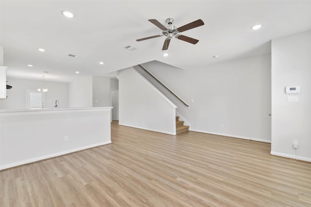 3907 Lynnfield St, Houston, TX 77016 - unfurnished living room with light wood-style flooring, recessed lighting, ceiling fan, baseboards, and stairs