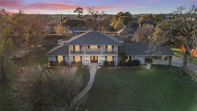 231 Corpus Dr, Magnolia, TX 77354 - view of front of property featuring a balcony, a front yard, roof with shingles, and stone siding