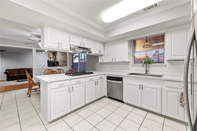231 Corpus Dr, Magnolia, TX 77354 - kitchen featuring appliances with stainless steel finishes, a sink, light countertops, ornamental molding, and light tile patterned floors
