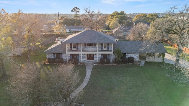 231 Corpus Dr, Magnolia, TX 77354 - view of front of house with a balcony, roof with shingles, and a carport