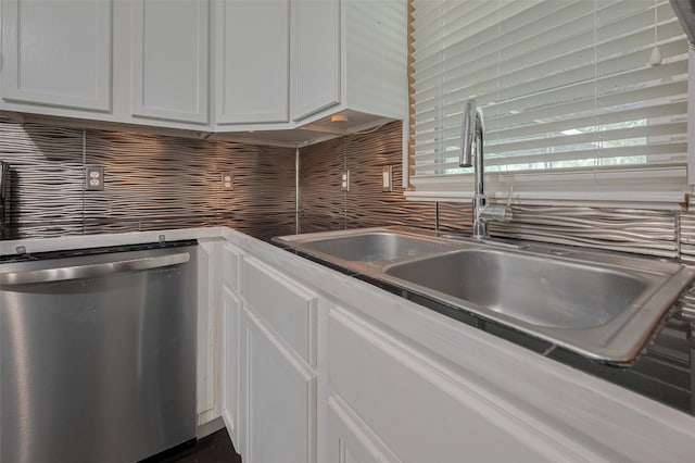 1402 W Norris, El Campo, TX 77437 - kitchen featuring dishwasher, a sink, decorative backsplash, and white cabinets
