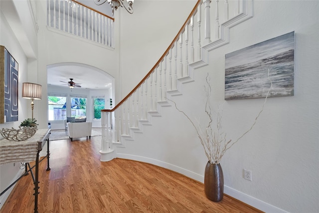 19715 Satinwood Trl, Humble, TX 77346 - entryway with wood finished floors, stairway, ceiling fan, baseboards, and a high ceiling
