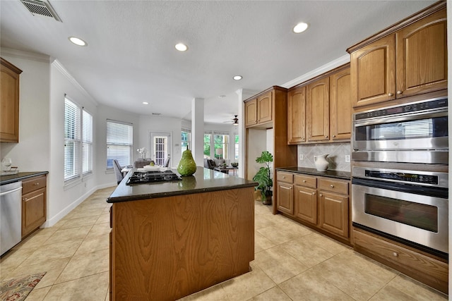 19715 Satinwood Trl, Humble, TX 77346 - kitchen with recessed lighting, a center island, light tile patterned floors, stainless steel appliances, and plenty of natural light