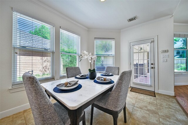 19715 Satinwood Trl, Humble, TX 77346 - dining area with healthy amount of natural light, ornamental molding, baseboards, and light tile patterned flooring