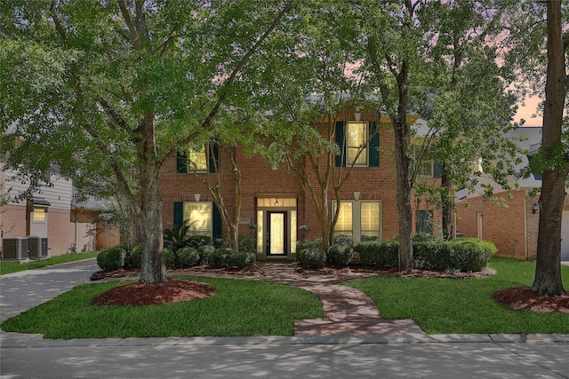 19715 Satinwood Trl, Humble, TX 77346 - view of front of house featuring cooling unit, brick siding, and a front yard