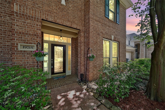 19715 Satinwood Trl, Humble, TX 77346 - exterior entry at dusk featuring brick siding