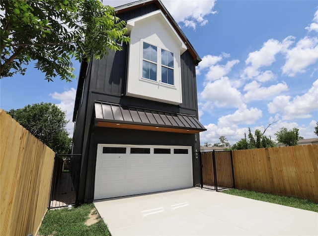 609 E 38th St, Houston, TX 77022 - view of home's exterior with a standing seam roof, a gate, driveway, and a garage