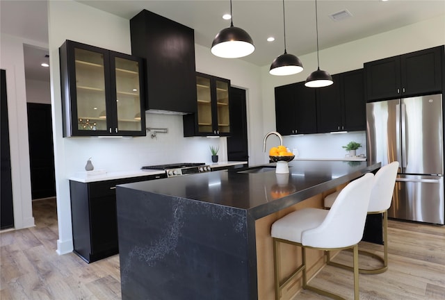 609 E 38th St, Houston, TX 77022 - kitchen with freestanding refrigerator, a sink, dark cabinetry, light wood finished floors, and recessed lighting