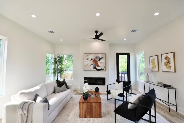 609 E 38th St, Houston, TX 77022 - living area featuring recessed lighting, plenty of natural light, a ceiling fan, light wood finished floors, and baseboards