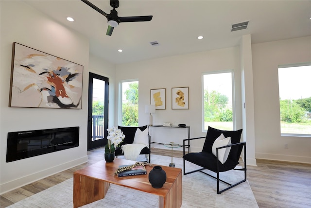 609 E 38th St, Houston, TX 77022 - living area with light wood-style flooring, a ceiling fan, baseboards, recessed lighting, and a glass covered fireplace