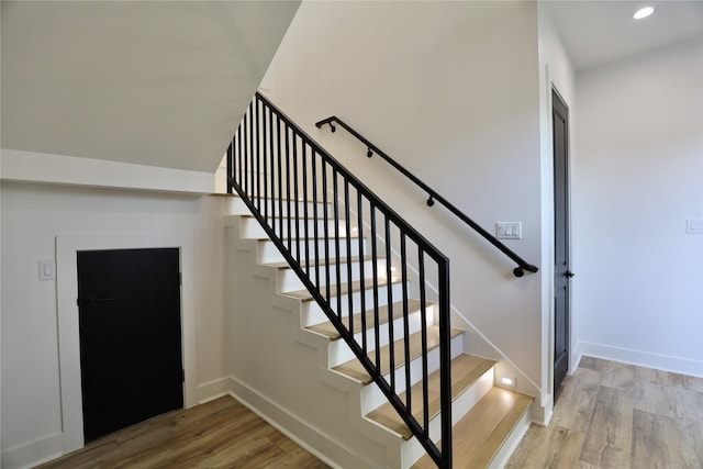 609 E 38th St, Houston, TX 77022 - stairway with wood finished floors, baseboards, and recessed lighting